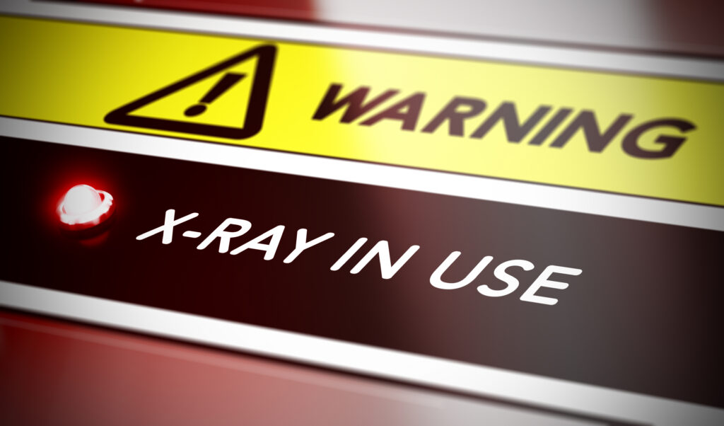 Illustration of x ray warning sign with red light and blur effect. X-Rey exposure or radiation concept